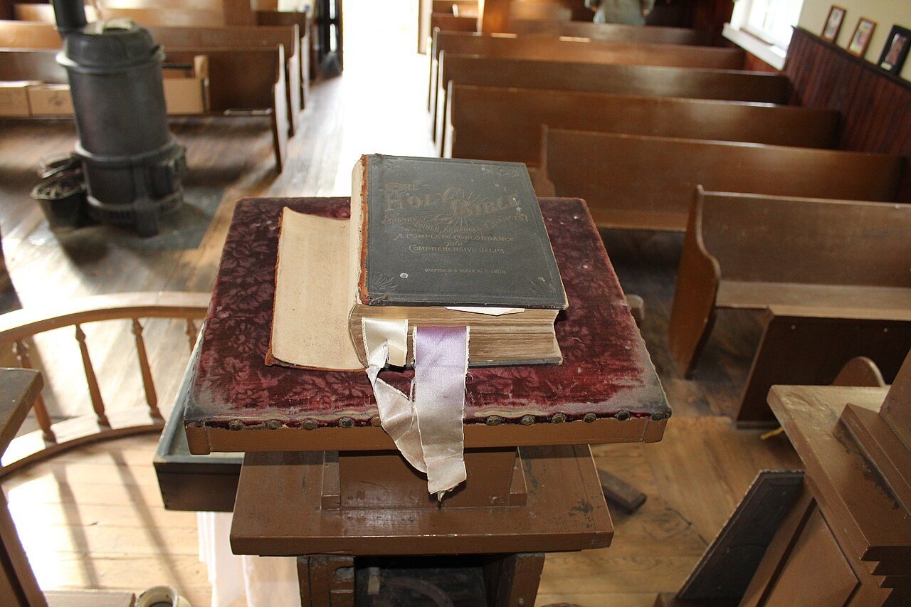 An aged bible on the pulpit in Tolson's Chapel looks out over wooden pews. A bible on the pulpit in Tolson's Chapel looks out over wooden pews. Keywor